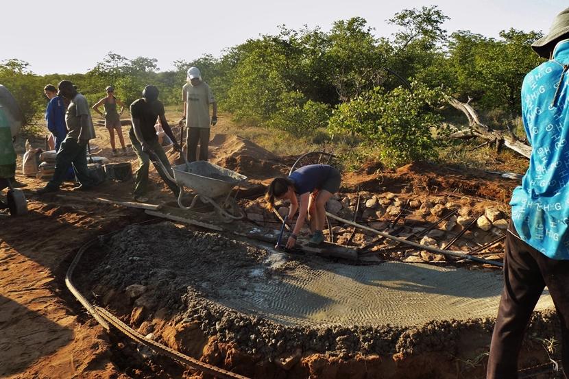 Conservation volunteers take part in the construction of a waterhole at Wild at Tuli game reserve Projects Abroad Bushveld Conservation volunteers work hard to build a waterhole at the Wild at Tuli game reserve in Botswana
