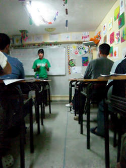 A Projects Abroad volunteer teacher in class with a group of students at her placement abroad. A Projects Abroad volunteer teacher in class with a group of students at her placement abroad.