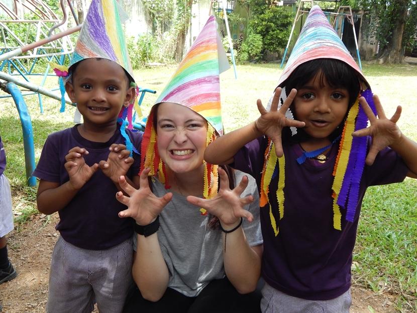Projects Abroad Care volunteer, Madeleine Westley from New Zealand, dresses up with young children at the Care project in Sri Lanka