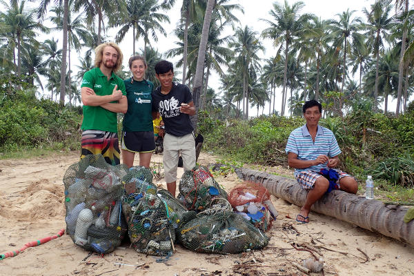 Projects Abroad staff and volunteers collect waste on a beach in Cambodia at the Diving & Marine Conservation Project.