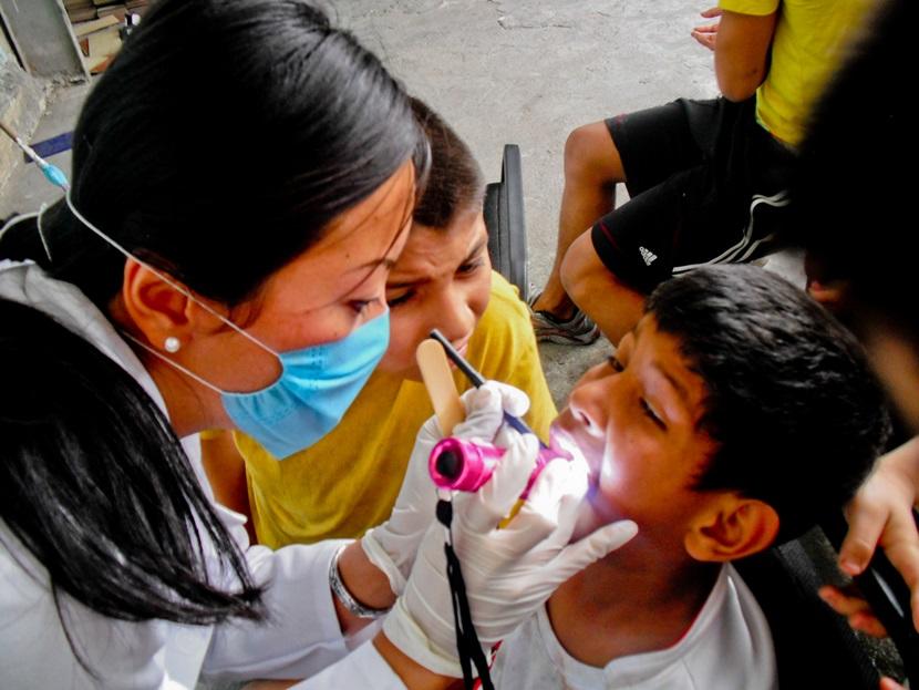 A Projects Abroad volunteer conducts a dental check-up for a child at a medical outreach in Guadalajara, Mexico. A Projects Abroad volunteer conducts a dental check-up for a child at a medical outreach in Guadalajara, Mexico.
