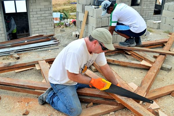 Use Your Experience and Skills to Impact Lives A Disaster Relief volunteer helps build a house for a family displaced by Typhoon Haiyan in the Philippines.