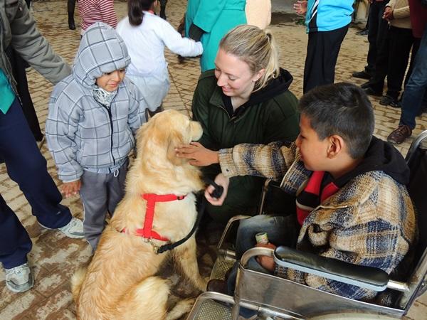 A Projects Abroad volunteer on the Canine Therapy Project in Bolivia helps young children interact with a trained therapy dog. A Projects Abroad volunteer on the Canine Therapy Project in Bolivia helps young children interact with a trained therapy dog.