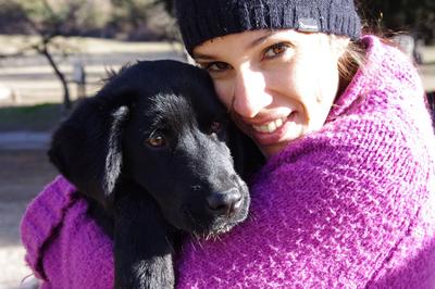 A volunteer hugs a dog on the Animal Care Project for teens in Argentina Help dogs at a shelter on the High School Special Animal Care Project in Argentina