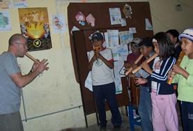 Creative & Performing Arts A volunteer on the Bolivia Creative & Performing Arts Projects teaches a child how to play a musical instrument.