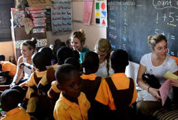 Ghana A group of High School Special Care & Community student volunteers play a game with children in a Ghana school.