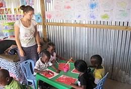 South Africa High school volunteers with children at the Care & Community Project in South Africa.