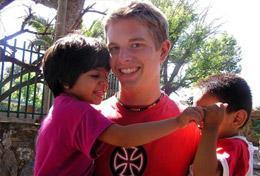 Argentina A High School Special Care & Spanish volunteer plays with children on the playground.