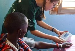 Tanzania Volunteers on the Public Health High School Special in Tanzania listen to the advice of a local doctor before a medical outreach.