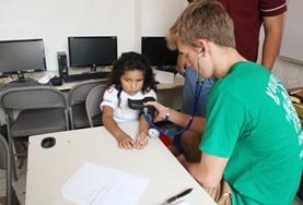 Mexico A Public Health High School Special Mexico volunteer checks the blood pressure of a young girl.
