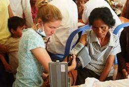 Cambodia A High School Special volunteer in Cambodia checks a woman's blood pressure on the Public Health Project.