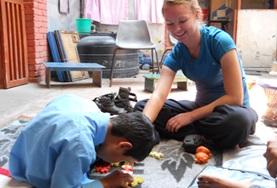 Nepal A student on the Physiotherapy High School Special in Nepal works with a young boy at her placement.