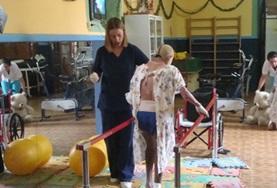 Medical School Electives A Physiotherapy School Elective student in Bolivia assists a boy with his therapy.