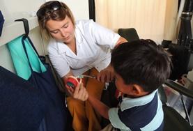 Medicine & Health Care A Nursing volunteer in Bolivia assists a young boy during her internship.