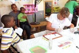 Jamaica A professional dentistry volunteer assists young children in Jamaica on the Professional Dental Project.