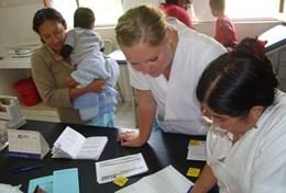 Medicine & Health Care A professional dietitian volunteer in Bolivia assists a local woman and her child during her project work.