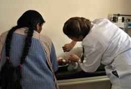 Medicine & Health Care A volunteer doctor examines a patient in a health clinic during his Professional Medical Project in Bolivia.
