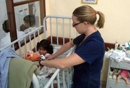 Medicine & Health Care A professional volunteer occupational therapist works with a young girl in Bolivia.