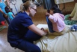 Medicine & Health Care A professional physiotherapy volunteer works with a child at a Bolivian hospital.