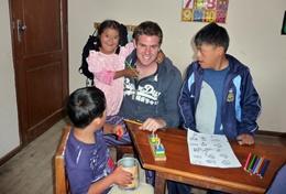 Teaching A professional special needs teacher volunteering in Bolivia helps children with an educational activity.