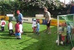 Sports A volunteer coaches soccer to young children in Bolivia.
