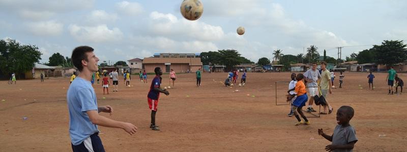 A Projects Abroad volunteer helps a child develop his soccer skills in a developing country abroad. A Projects Abroad volunteer helps a child develop his soccer skills in a developing country abroad.